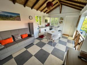 a living room with a couch and a table at Ti bijou in Baie-Mahault
