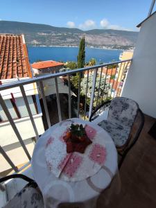 a plate of cake on a table on a balcony at Smestaj Vella in Herceg-Novi