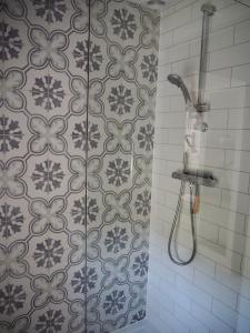 a shower in a bathroom with a tile wall at North Devon Holiday Cottage Dog Friendly with Local Pub in Swimbridge