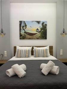 a bedroom with a bed with two pillows on it at Coastline of paradise 2 in Paránimfoi