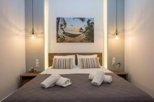 a bedroom with a large bed with two pillows at Coastline of paradise 2 in Paránimfoi