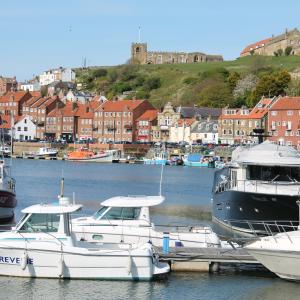 two boats are docked at a dock in a harbor at Garden Cottage in Guisborough