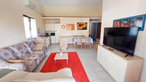 a living room with a couch and a flat screen tv at Apartman Lucija in Rovinj