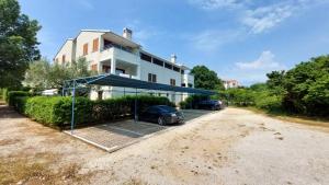 a car parked in a parking lot in front of a house at Apartman Lucija in Rovinj