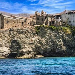 a group of buildings on top of a rocky cliff at Sea life Terrasini in Terrasini