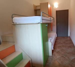 a room with a bunk bed on top of a staircase at Al 28ᴀ , Appartamento Teulada in Teulada