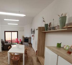 a kitchen and living room with a table and a living room at Al 28ᴀ , Appartamento Teulada in Teulada