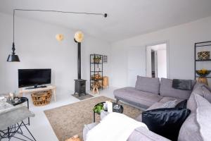 a living room with a couch and a tv at Villa Sofia Old Town in Kavala