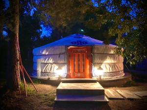 a yurt with a red door at night at Yurta Arco Iris in Riba-Roja De Turia