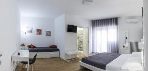 Letto o letti in una camera di B&B In Piazza