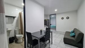 a room with a table and a chair and a bathroom at Dorada Hospedaje in Mazatlán +84 photos