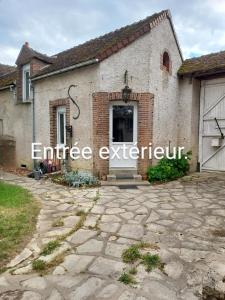 a brick building with the word entranceexit written on it at La Chaumière de Medee in Cuy