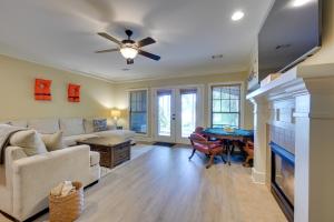 a living room with a couch and a table at Lake Oconee Abode with Patio, Grill and Fire Pit Table in Eatonton 