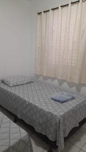 מיטה או מיטות בחדר ב-Quarto em Apto ao lado Shopping