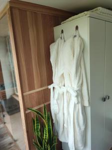 a towel hanging on a door of a cabinet at Ô nature in Grez-Doiceau
