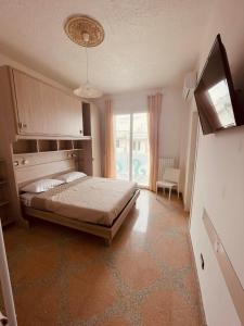 a bedroom with a bed and a large window at Tina's House Luxury Room in Copertino