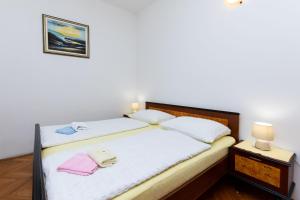Posteľ alebo postele v izbe v ubytovaní Apartments Marija Sabina