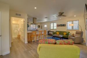 a living room and kitchen with a couch and a table at Old Town Cottonwood Cottage with Mod Interior! in Cottonwood