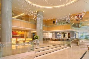 a lobby of a shopping mall with a chandelier at Sheraton Nha Trang Hotel & Spa in Nha Trang