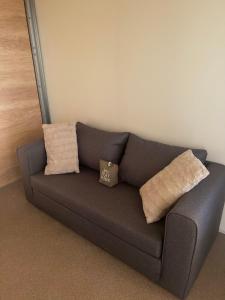 a couch with two pillows on it in a room at Mobile Home L&L in Drage