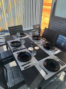 a table with plates and wine glasses on it at Mobile Home L&L in Drage