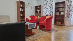 a living room with two chairs and a couch at Romantic2 in Szeged