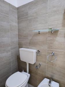 a bathroom with a toilet and a sink at Sicily Guest House in Gela