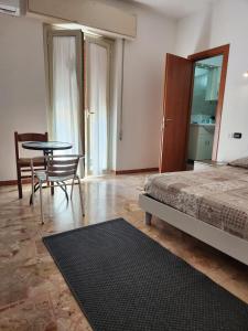 a bedroom with a bed and a table and chairs at Sicily Guest House in Gela