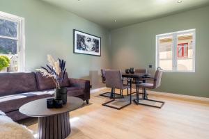 a living room with a couch and a table at Trolltunga View in Tysso