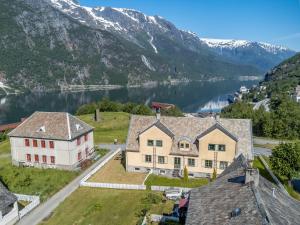 an aerial view of a house with a lake and mountains at Trolltunga View in Tyssedal