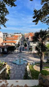 a street with a fountain in the middle of a city at Vue MER/Tout à pied/Calme/Plage/ Parc Mauresque in Arcachon