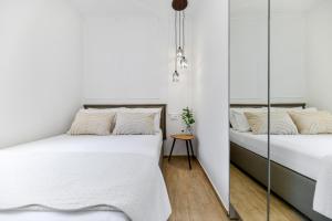 two beds in a room with white walls at Apartment "Libra" Zadar in Zadar