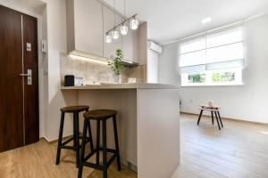 a kitchen with two bar stools and a counter at Apartment "Libra" Zadar in Zadar