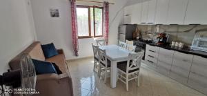 a living room with a couch and a table in a kitchen at Holiday Home 2 Palma in Durrës