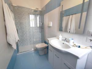 a bathroom with a toilet and a sink and a shower at Porto Selvaggio Casa Zaffiro in Torre Inserraglio