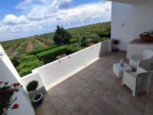 a balcony with a view of a vineyard at Casa Zaffiro - Sant' Isidoro - Porto selvaggio -Porto cesareo in Torre Inserraglio