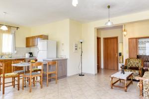 a kitchen and living room with a table and chairs at Catherine's House in Igoumenitsa