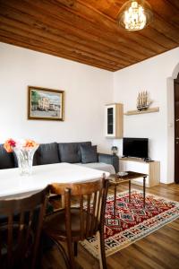 a living room with a table and a couch at Emblematic House Apartment 1 in Gjirokastër