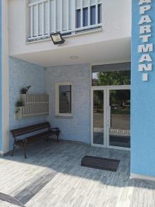 a room with a bench and a building at Studio apartmani Banja Koviljaca in Banja Koviljača +44 photos