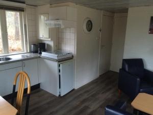 a small kitchen with a sink and a stove at Vosseven 27 Heksenkring in Stramproy +9 photos