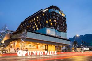 a building with a sign in front of a street at The Westin Monterrey Valle in Monterrey