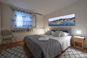 a bedroom with a bed and a tv on the wall at Apartment Z in Zlarin