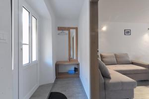 a living room with a couch and a window at Apartment Z in Zlarin