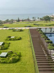 a walkway leading down to a pool of water at Nice appartement pool & sea view in Dar Bouazza