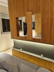 a bedroom with a bed and two mirrors at Apart Rivadavia340 in Neuquén