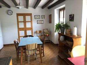 a dining room with a blue table and chairs at Gîte du champ de la Briette in Villers-lès-Bois