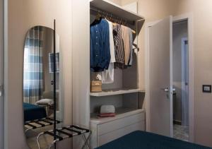 a bathroom with a mirror and a closet with clothes at Luxor Home Vista incantevole in Agrigento