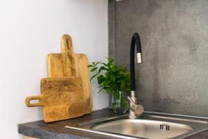 a kitchen sink with a wooden cutting board next to it at Gioia I & Gioia II in Rethymno +38 photos