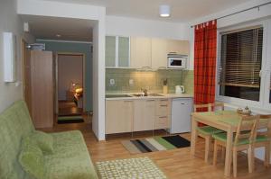 a kitchen with a table and a dining room at Nová Ponorka Martinské Hole Martinky in Demanovska Dolina