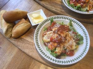 a plate of food with a salad and bread on a table at Nether Dallachy Farmhouse in Banff